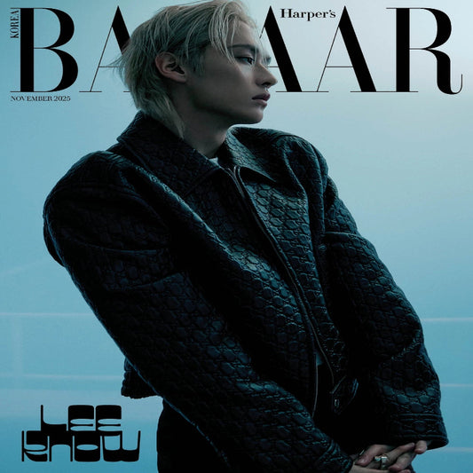 Harper's Bazaar Korea magazine cover with a person wearing a dark coat against a blue gradient background.