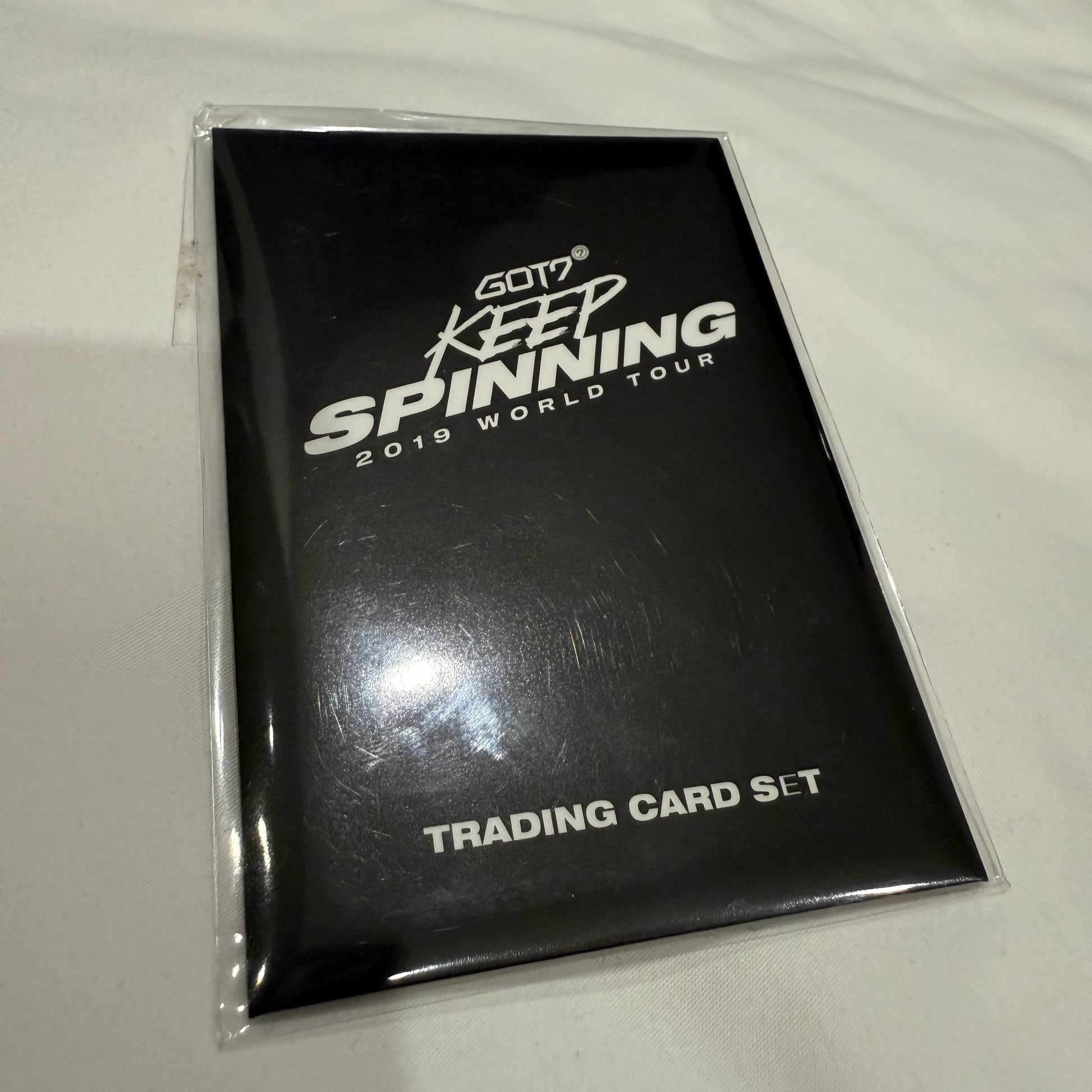 Trading card set packaging with 'GOT7 Keep Spinning 2019 World Tour' text on a white background