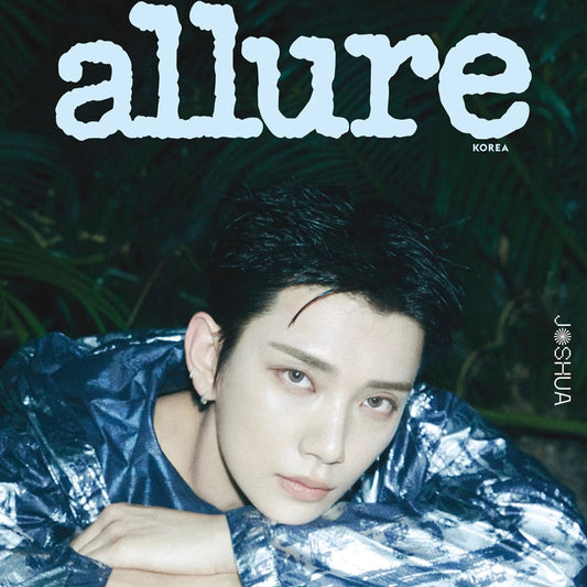 Person wearing a reflective silver jacket on the cover of 'allure' magazine with a dark, leafy background.